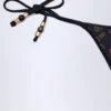 Bas de bikini string Cebu avec détails charmants, en noir Bas de bikini string Cebu avec détails charmants, en noir