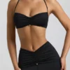 Brassière dos nu en jersey fluide avec détails métalliques Jerika, en noir Brassière dos nu en jersey fluide avec détails métalliques Jerika, en noir