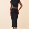 Crop top à manches courtes Myaree en noir Crop top à manches courtes Myaree en noir