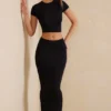 Crop top à manches courtes Myaree en noir Crop top à manches courtes Myaree en noir