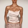 Haut corset drapé en satin et dentelle Yulea, couleur or Haut corset drapé en satin et dentelle Yulea, couleur or