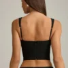 Haut corset Pearla noir avec découpes et nœuds Haut corset Pearla noir avec découpes et nœuds