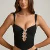 Haut corset Pearla noir avec découpes et nœuds Haut corset Pearla noir avec découpes et nœuds