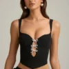 Haut corset Pearla noir avec découpes et nœuds Haut corset Pearla noir avec découpes et nœuds
