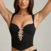 Haut corset Pearla noir avec découpes et nœuds Haut corset Pearla noir avec découpes et nœuds