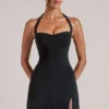 Jupe moulante taille moyenne Tula avec fente, en noir Jupe moulante taille moyenne Tula avec fente, en noir