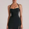 Jupe moulante taille moyenne Tula avec fente, en noir Jupe moulante taille moyenne Tula avec fente, en noir