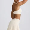 Mini-jupe-short croisée en jersey brossé marbré ivoire Mini-jupe-short croisée en jersey brossé marbré ivoire