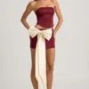 Mini-jupe taille basse Carola en satin avec nœud, couleur rouge vin Mini-jupe taille basse Carola en satin avec nœud, couleur rouge vin