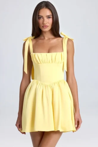 Mini-robe corset drapée Bellamy en Lemon Sherbet