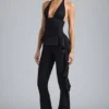 Pantalon évasé taille basse à volants Reese métallisé en noir Pantalon évasé taille basse à volants Reese métallisé en noir