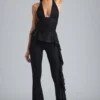 Pantalon évasé taille basse à volants Reese métallisé en noir Pantalon évasé taille basse à volants Reese métallisé en noir