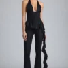 Pantalon évasé taille basse à volants Reese métallisé en noir Pantalon évasé taille basse à volants Reese métallisé en noir