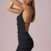 Robe Tarryn à volants, dos nu et col licou, en noir Robe Tarryn à volants, dos nu et col licou, en noir
