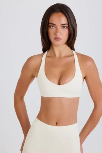Soutien-gorge de sport à dos croisé et encolure en V, couleur crème