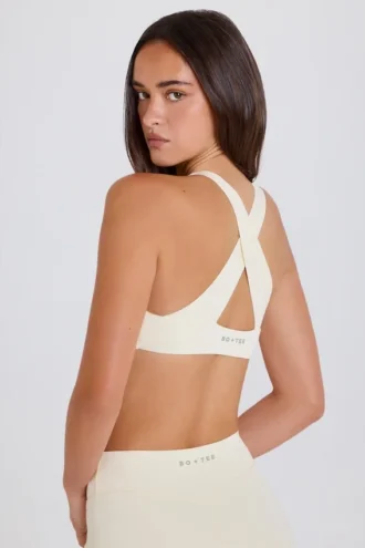 Soutien-gorge de sport à dos croisé et encolure en V, couleur crème