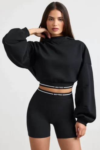 Sweat à capuche court en molleton de coton extensible, noir