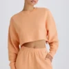 Sweat-shirt court à dos ouvert en jersey de coton texturé, couleur pêche